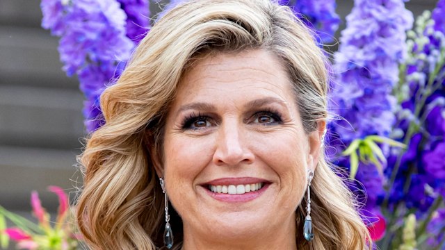 Queen Maxima smiling waist up in blue dress