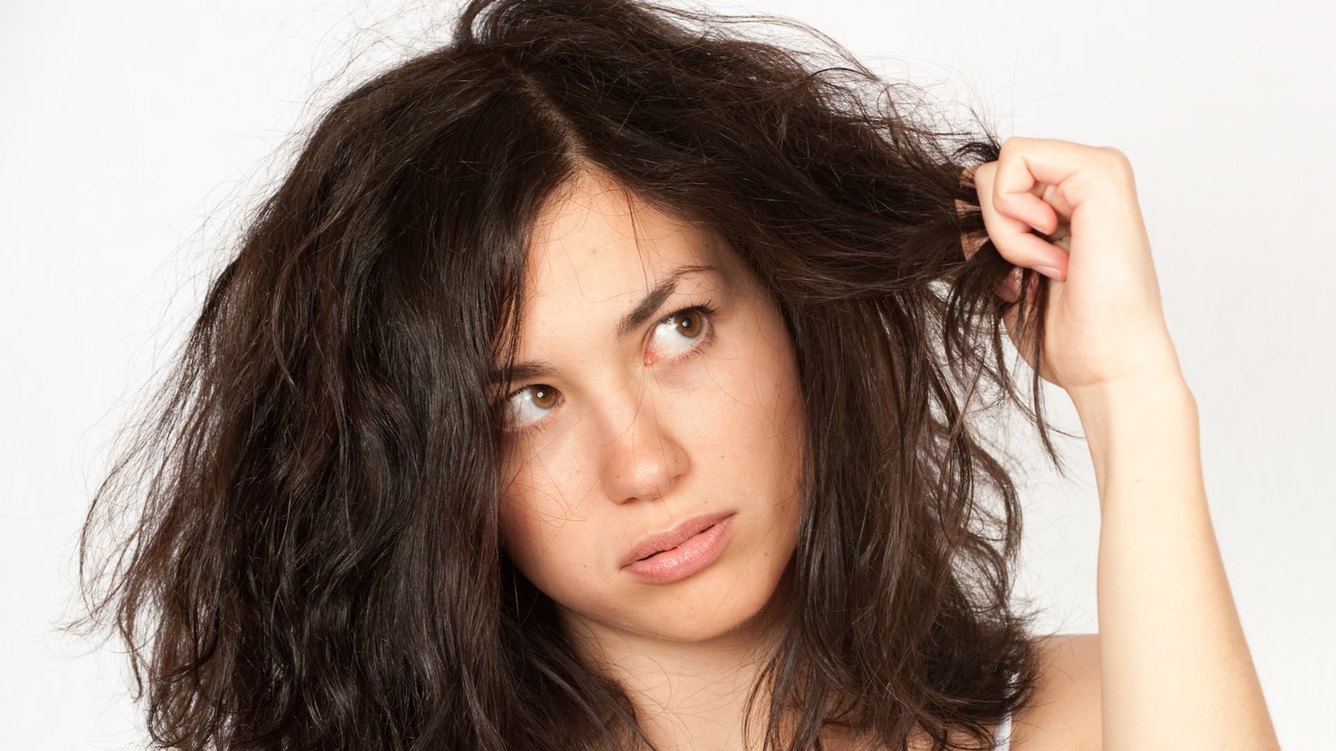 A woman looking at her bad hair.