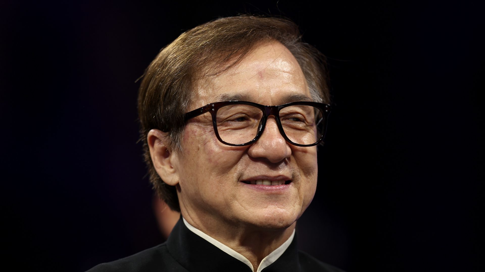 Jackie Chan waves to the crowd during the medal ceremonies on day one of the Paris 2024 Summer Paralympic Games at Grand Palais on August 29, 2024 in Paris, France.