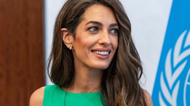 Amal Clooney in green dress with brunette hair