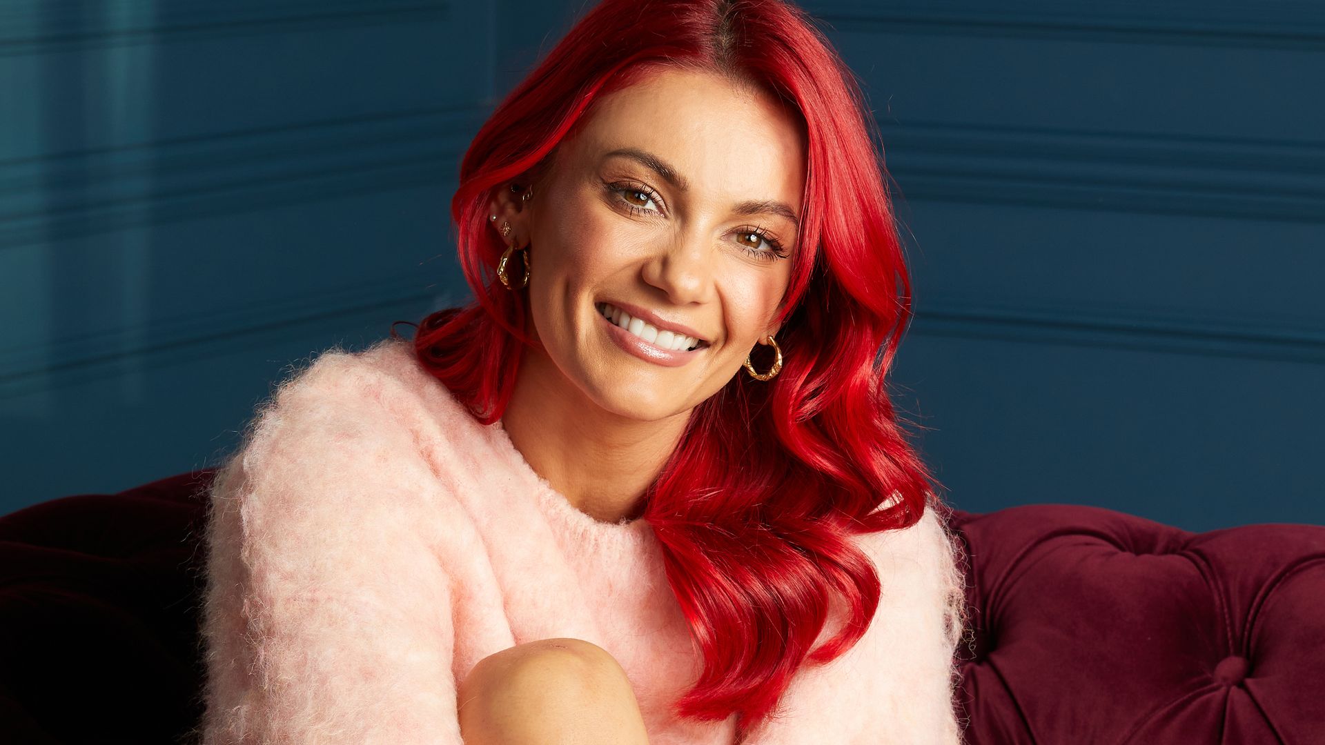 Dianne Buswell wearing a pink jumper