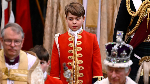 Page of Honour Prince George of Wales and Britain's King Charles III wearing the Imperial state Crown leave Westminster Abbey after the Coronation Ceremonies in central London on May 6, 2023. 