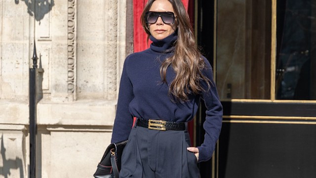 Victoria Beckham wearing sunglasses, walking towards the camera