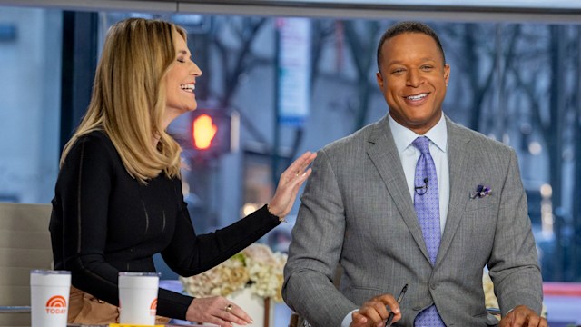 TV anchors laughing in studio 