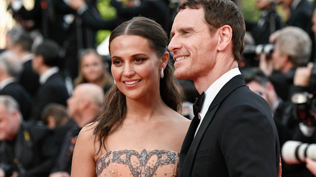 Michael Fassbender in black tux and Alicia Vikander in nude and silver dress