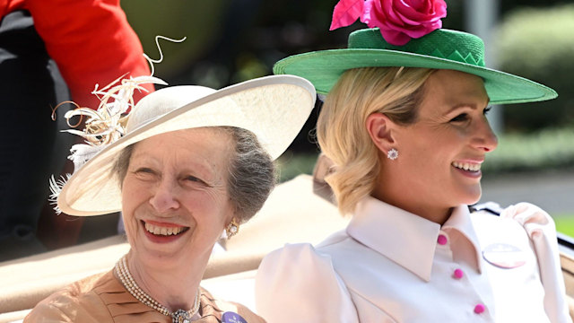 Princess Anne and Zara Tindall at Ascot in 2022 riding in a carriage in smart clothes
