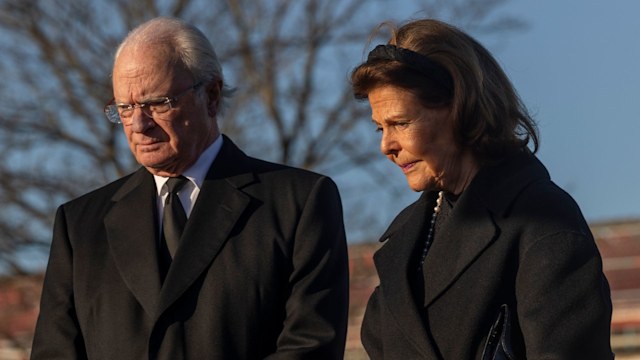 King Carl XVI Gustaf and Queen Silvia light candles at a memorial site to honor the victims of the school shooting on February 5, 2025 in Orebro, Sweden