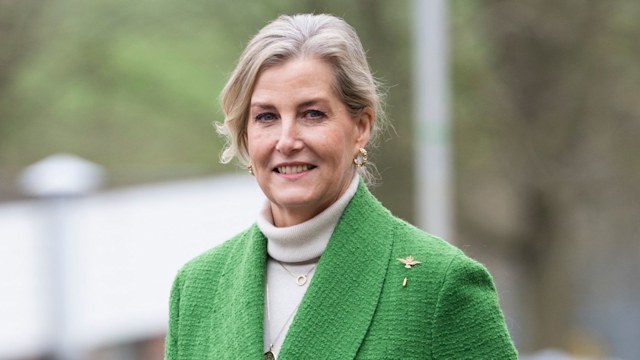 Blonde woman wearing green walking
