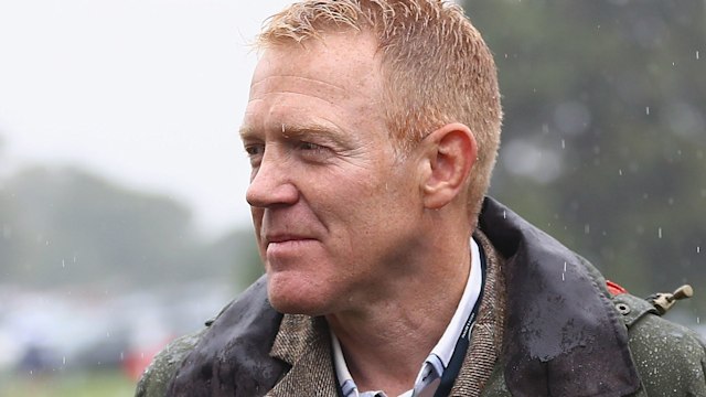 Adam Henson in the rain wearing a green jacket