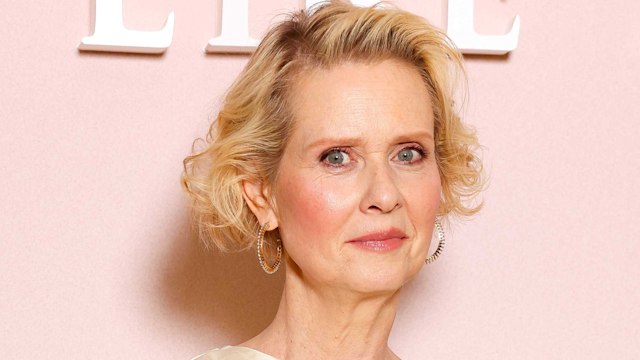 Cynthia Nixon on red carpet in white dress