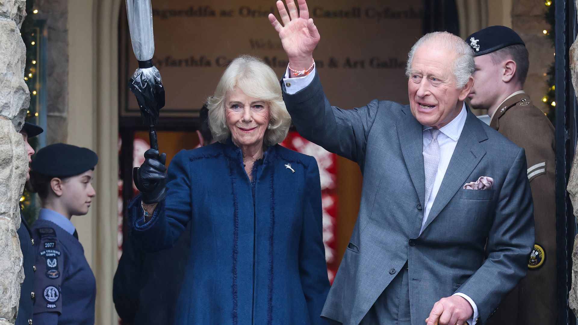 Queen Camilla and King Charles wave as they depart from a visit to Cyfarthfa Castle 