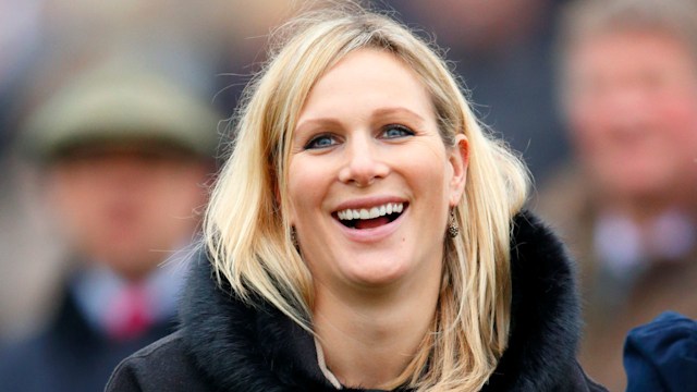 Zara Phillips smiling in blue poncho