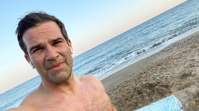 man posing for selfie by sea 