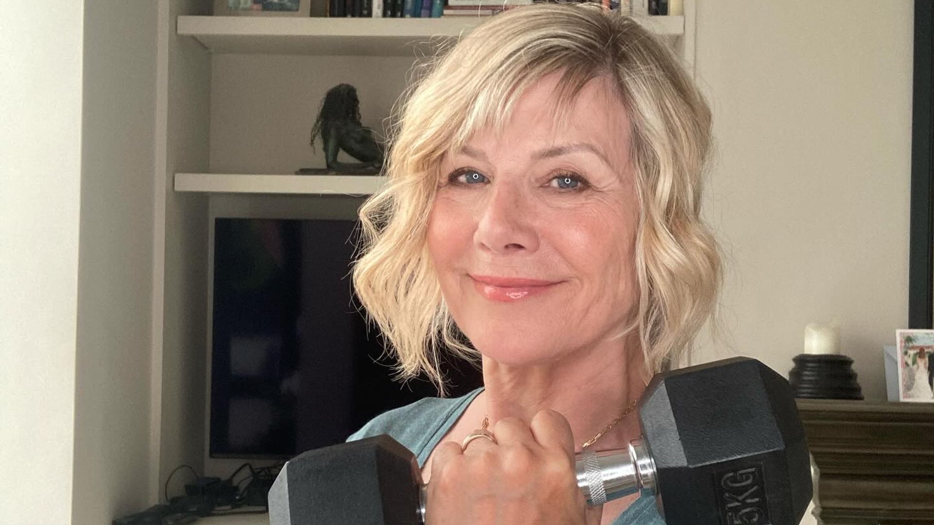 Woman holding a weight and smiling