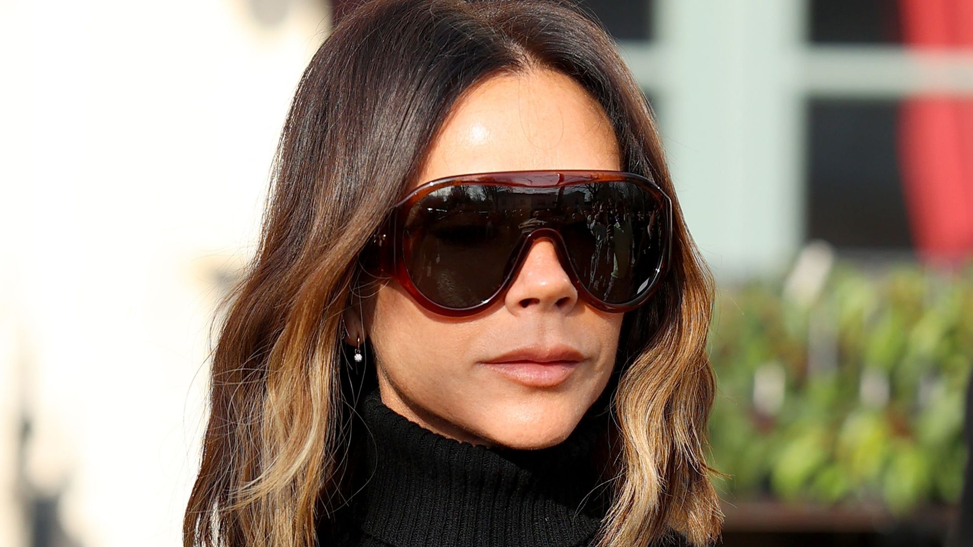 Victoria Beckham wearing sunglasses during Paris Fashion Week 2025