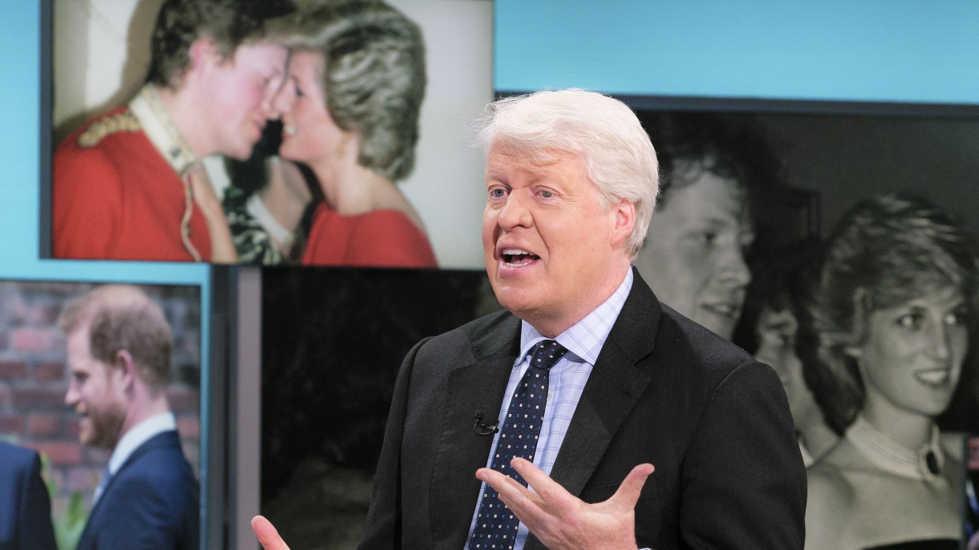 man chatting on live tv in dark suit and tie