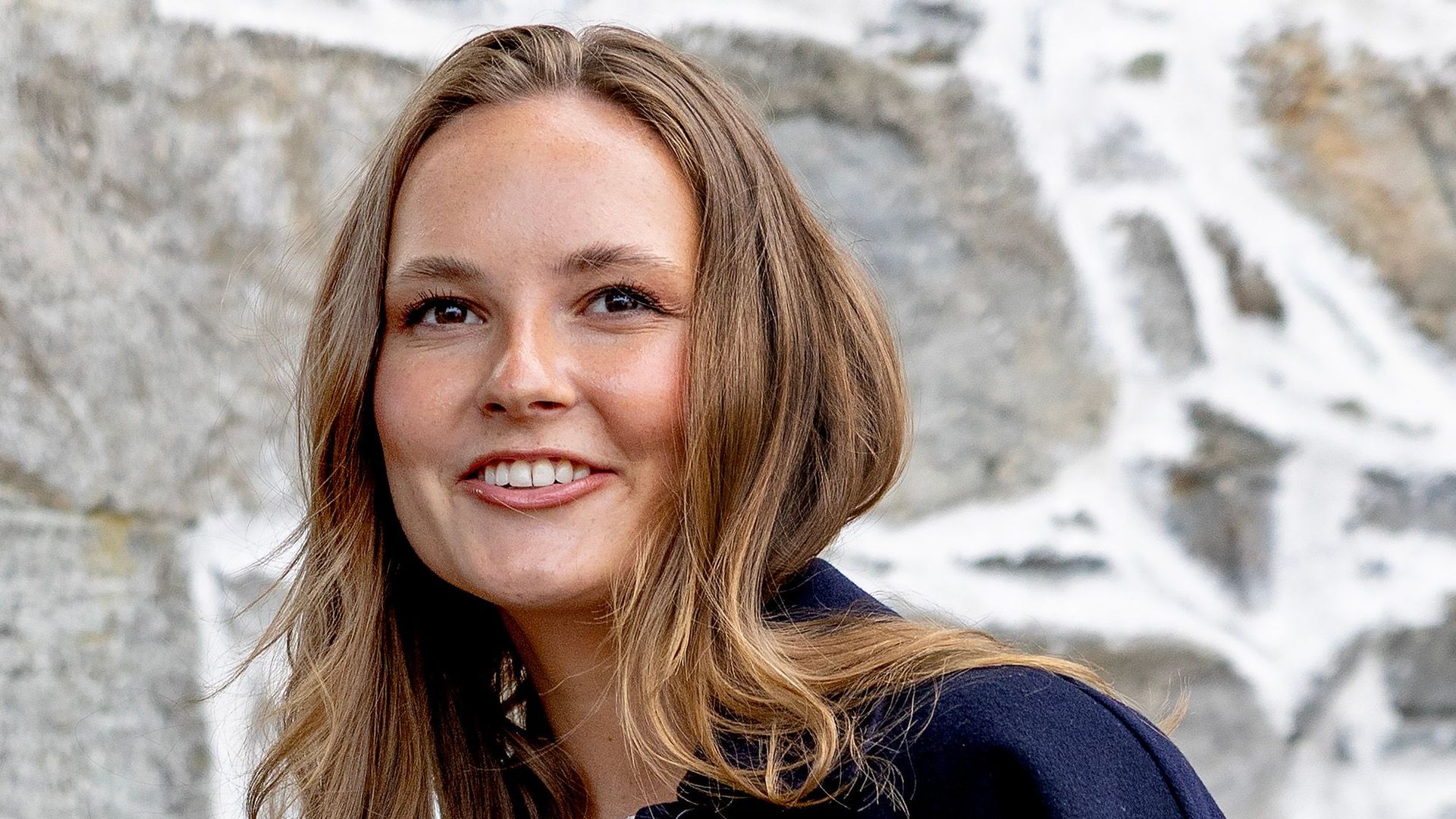 Princess Ingrid Alexandra smiling in navy blazer and lace top