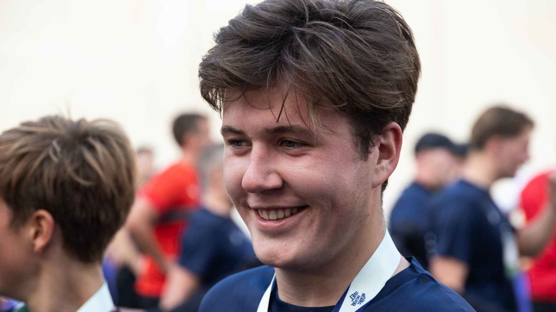 Crown Prince Christian wearing medal speaking to press
