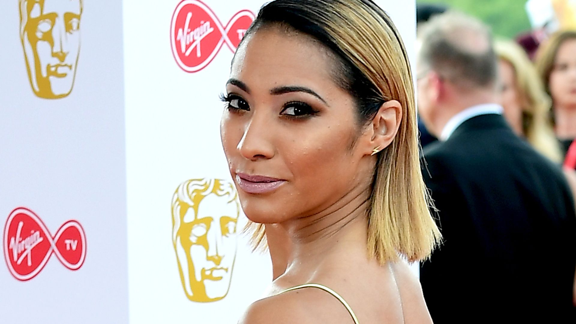 Karen Hauer in a yellow satin slip dress on the red carpet at the Virgin TV British Academy Television Awards 2018 