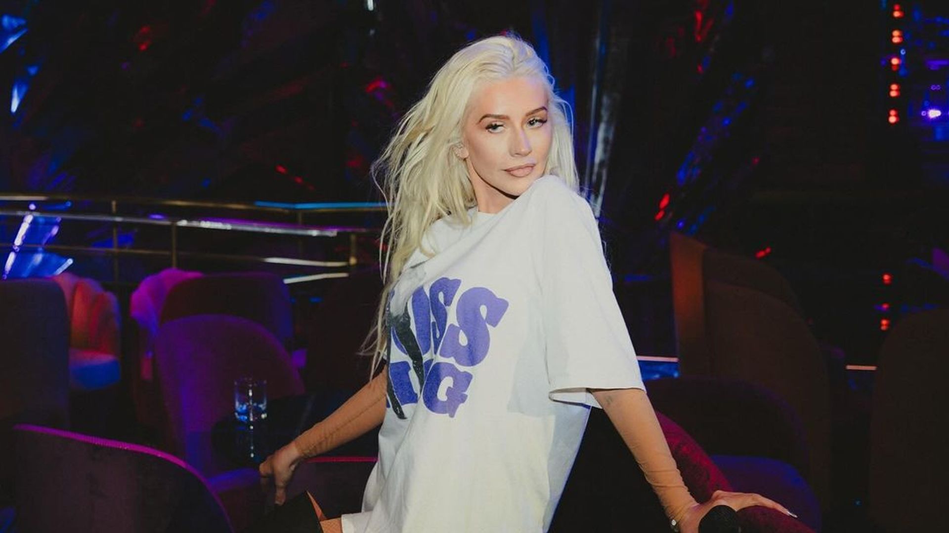 Christina Aguilera showcases her slender physique in T-shirt and thigh-high boots after losing 50 pounds