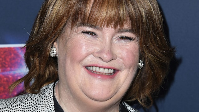Susan Boyle smiling for a photo at a red carpet event