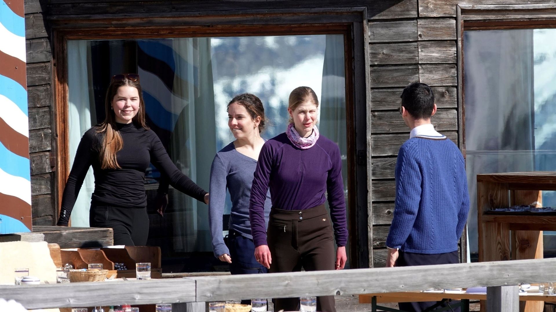 Lady Louise Windsor leaving a wooden building with two friends