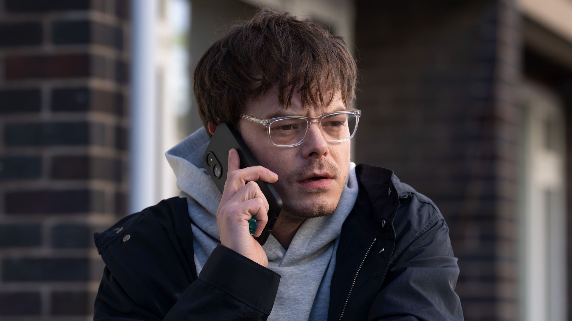 man on phone smoking cigarette