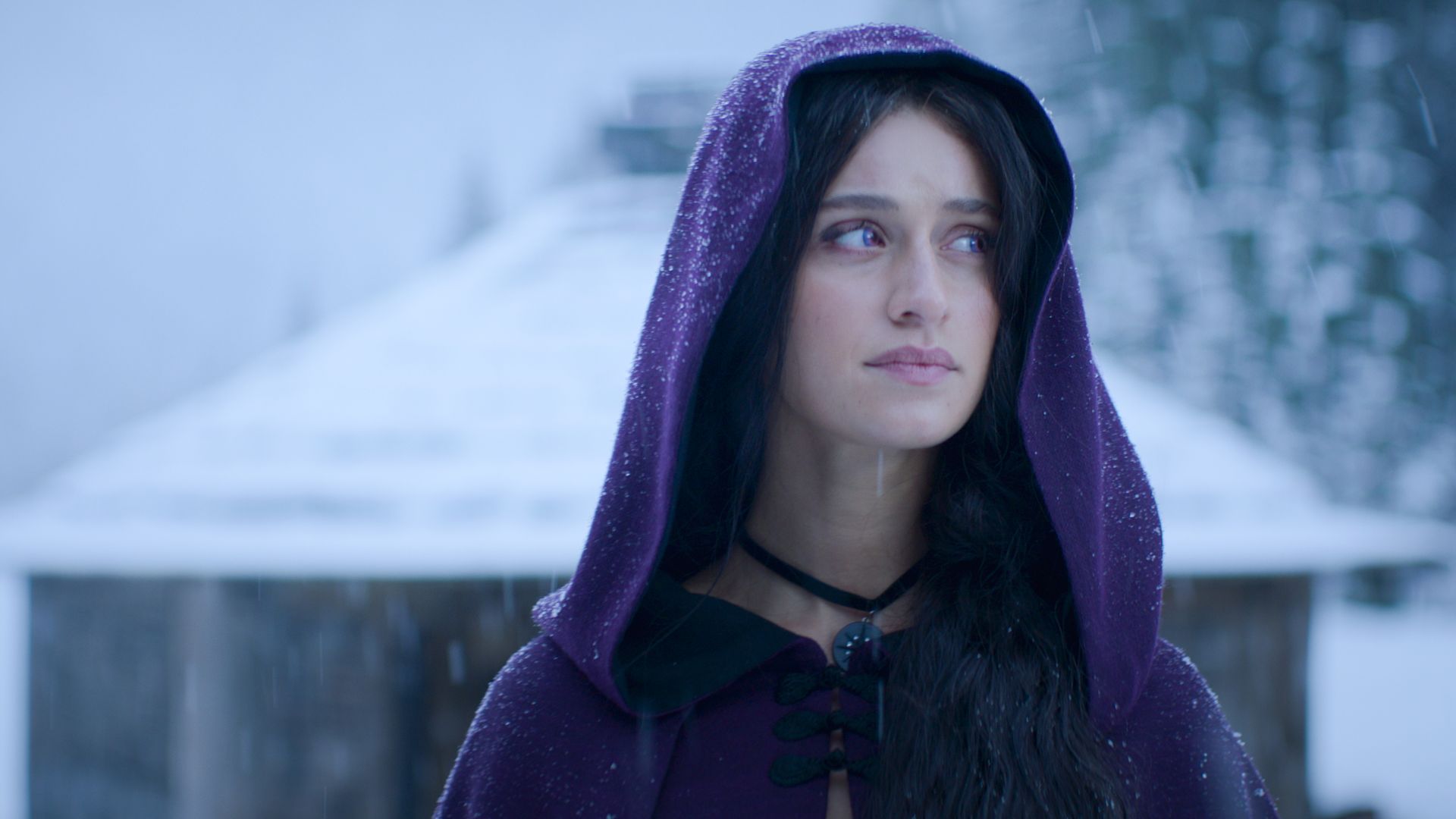 Yennefer wearing a purple cloak in The Witcher season three. 