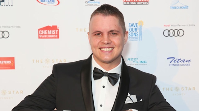 Johnny Ruffo wearing a tuxedo on the red carpet. 