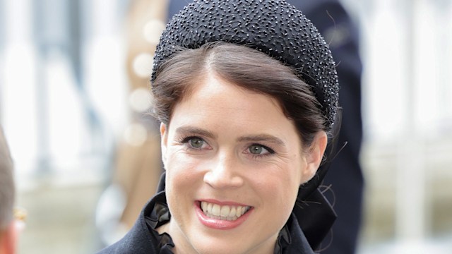 Princess Eugenie smiling while in a black outfit