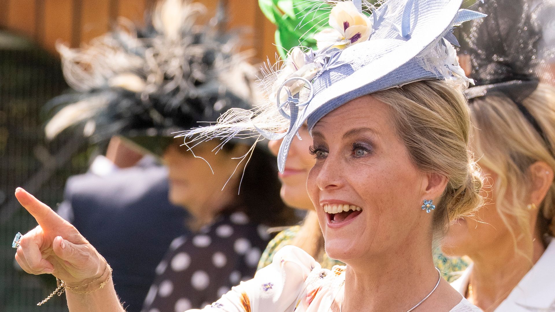 Sophie, Duchess of Edinburgh smiling widely and pointing at Royal Ascot