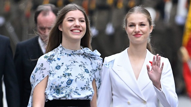 Infanta Sofia walking with a waving Princess Leonor and Queen Letizia