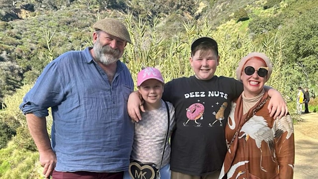 family-of-four posing near hollywood sign