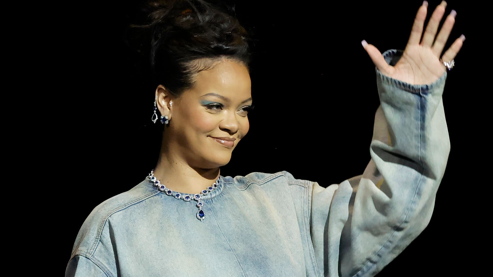 Rihanna speaks onstage, promoting the upcoming Smurfs film