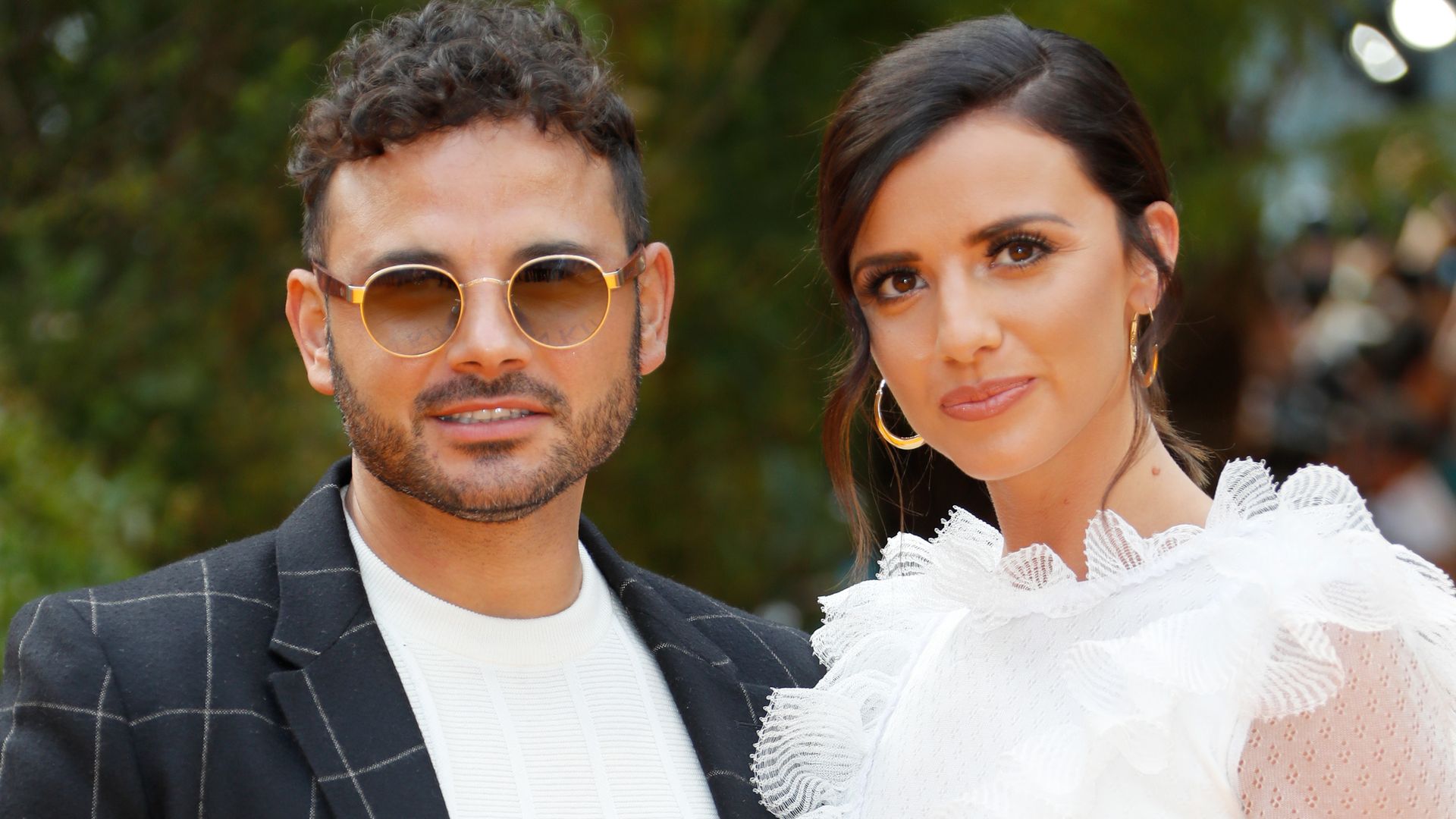 Ryan Thomas in a patterned suit and Lucy Mecklenburgh in a white ruffled dress