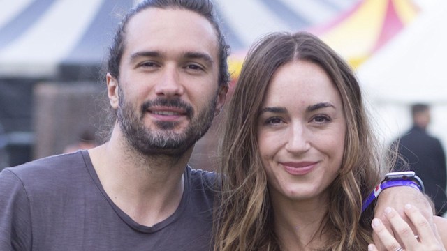 Joe Wicks in a T-shirt with his arm around her shoulders