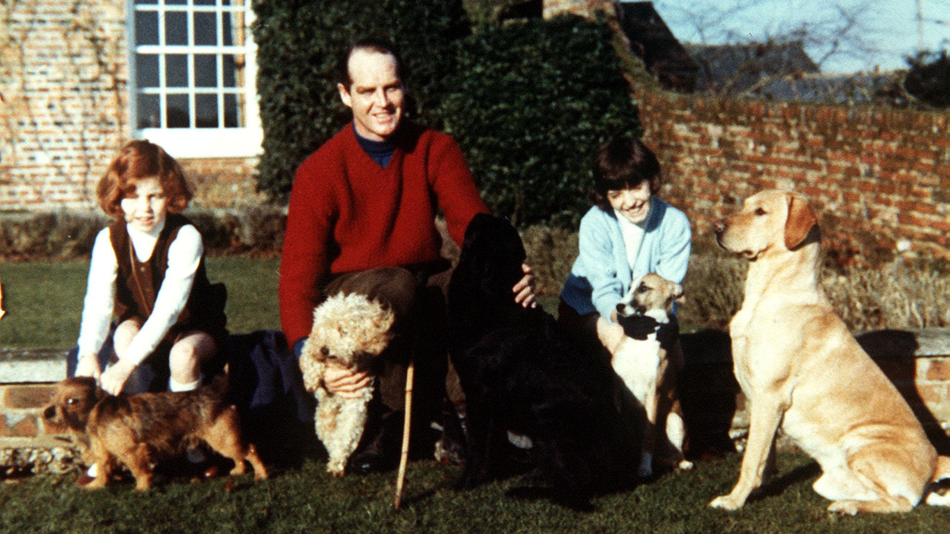 A young Sarah and Jane Ferguson with Ronald Ferguson and four dogs