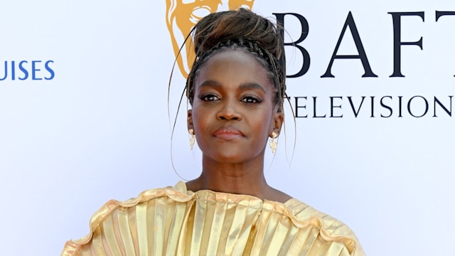 A photo of Oti Mabuse wearing a gold dress at the BAFTAs