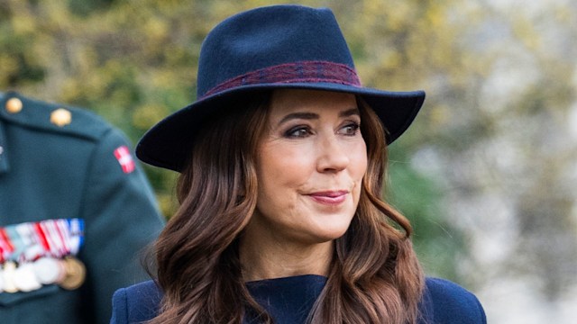 Queen Mary in navy coat and hat