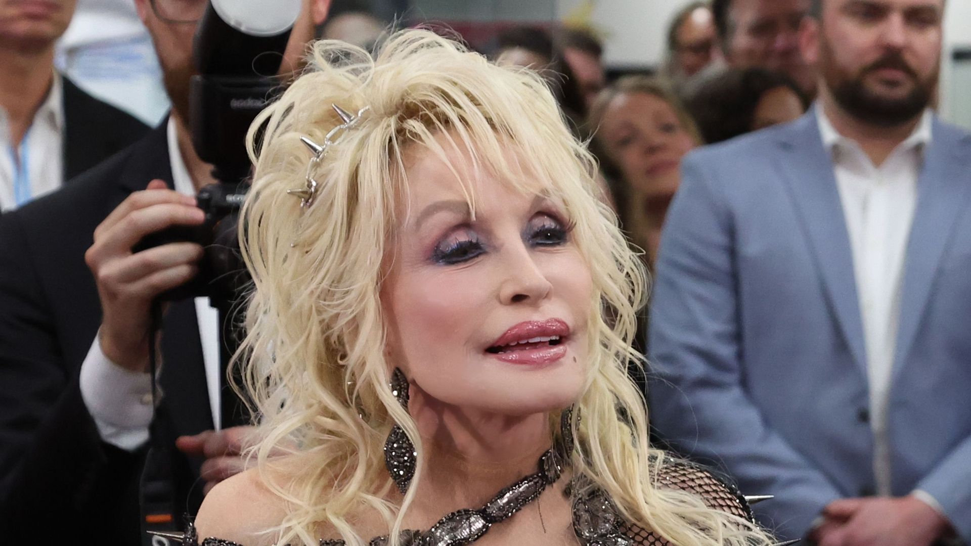 Dolly Parton in a snake print dress