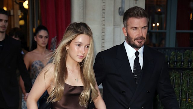 Harper Beckham walking alongside David Beckham