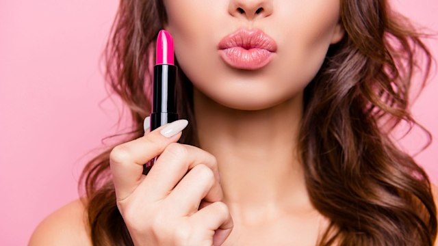 woman pouting with a lipstick