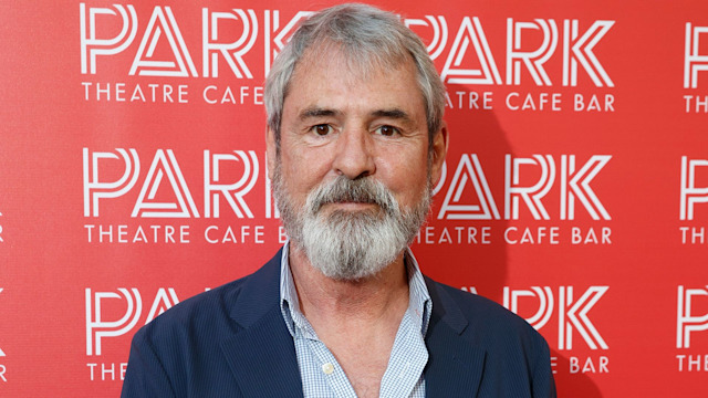 Neil Morrissey wearing a navy suit. 