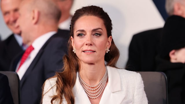 Kate Middleton sitting in a white outfit