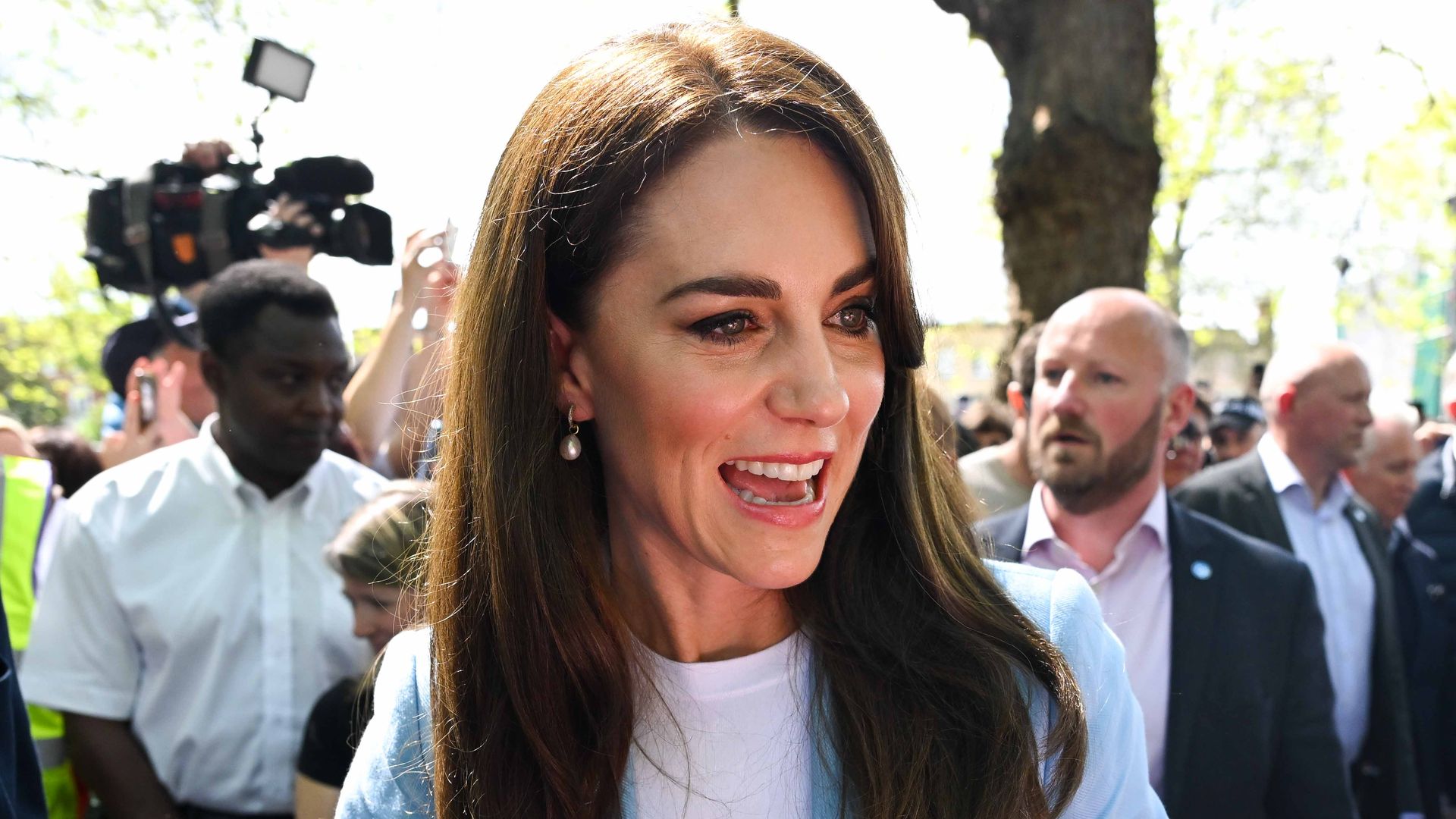 Princess Kate smiling in a blue jacket 