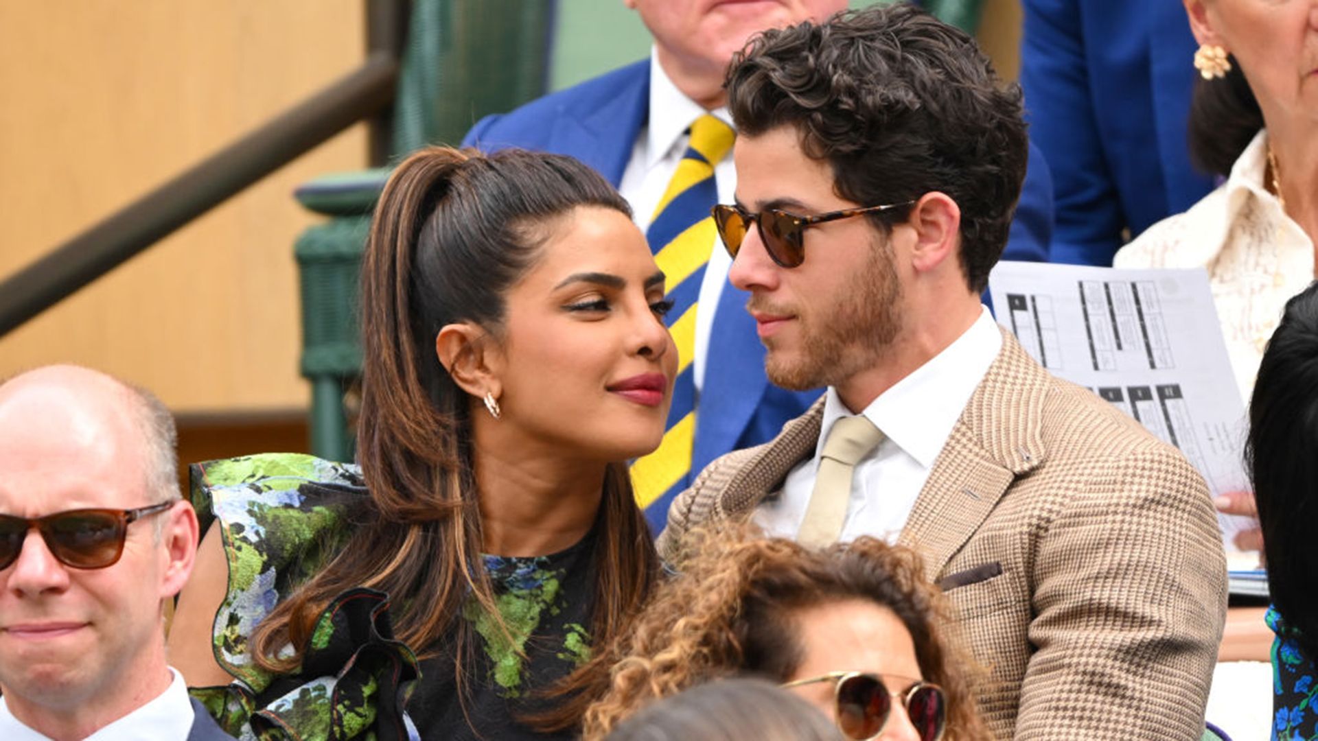 Priyanka Chopra-Jonas leaning into Nick Jonas at Wimbledon