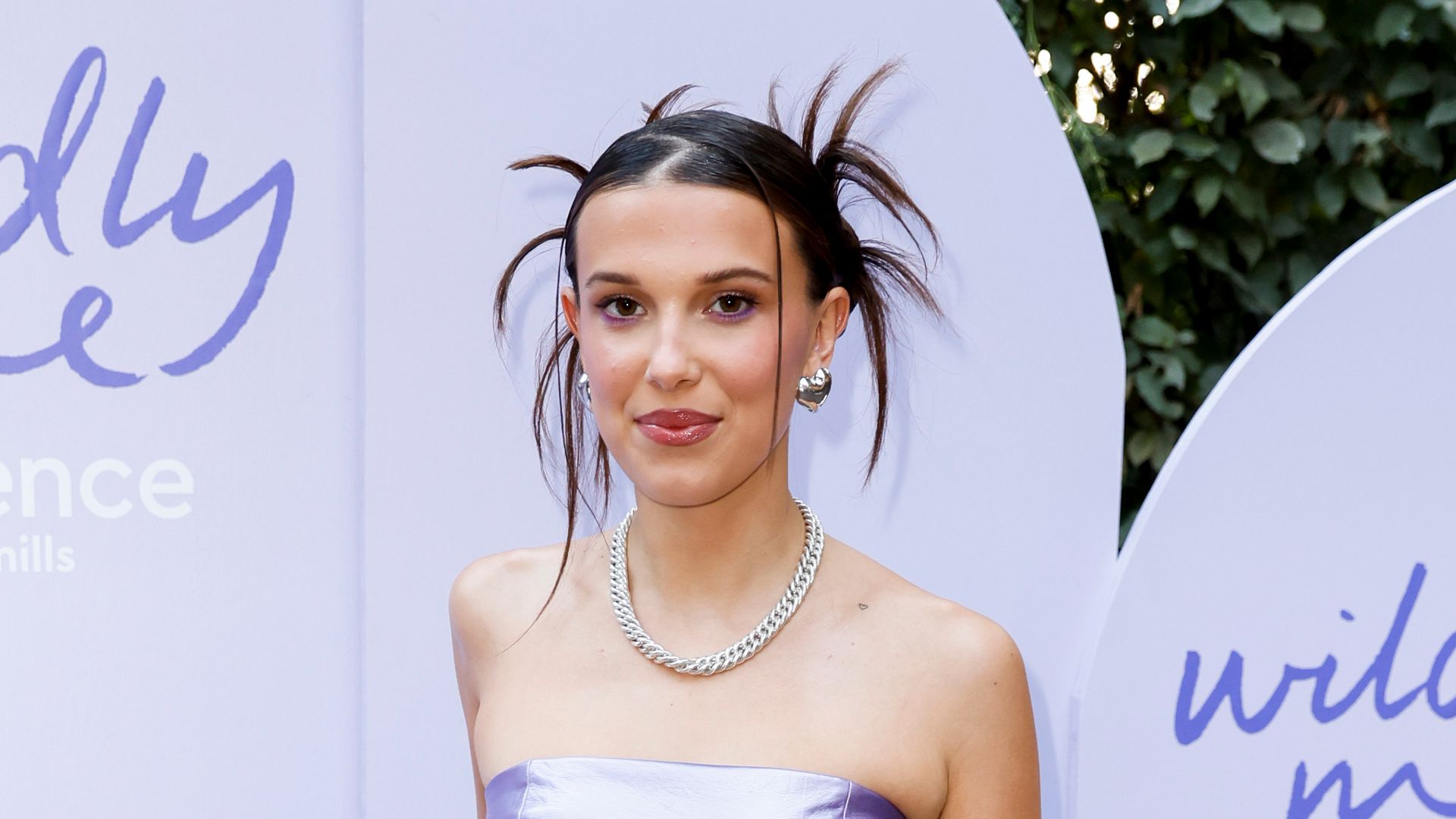 Millie Bobby Brown forced to adjust her plunging pink dress at