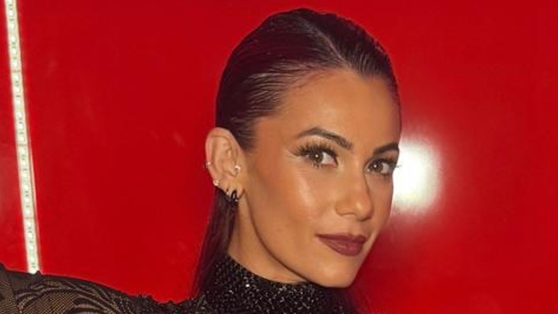 Dianne Buswell displays baby bump in sheer catsuit: 'He's certainly grown'