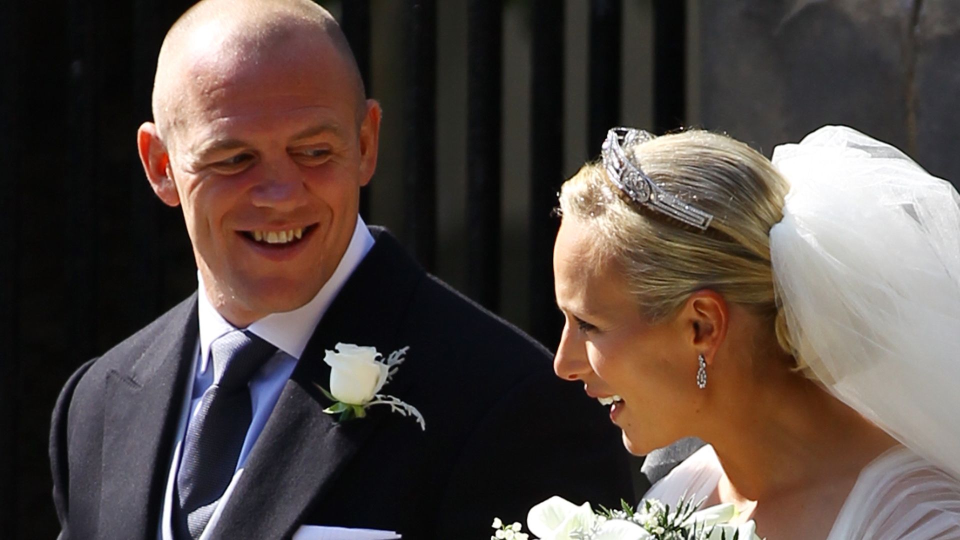 Mike Tindall looking at his wife Zara Phillips on their wedding day