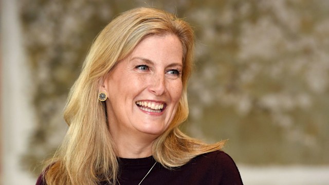 Duchess Sophie smiling and looking to the side wearing a dark jumper
